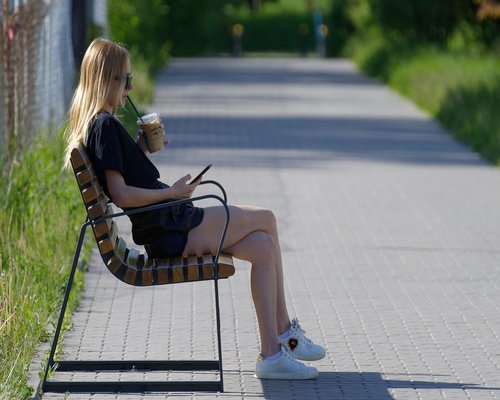 A person taking a break, drinking water while working on a laptop