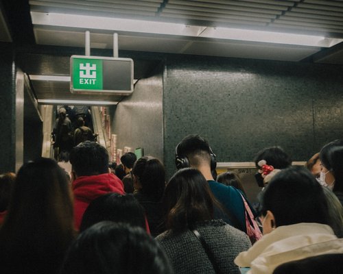 People commuting via train standing comfortably
